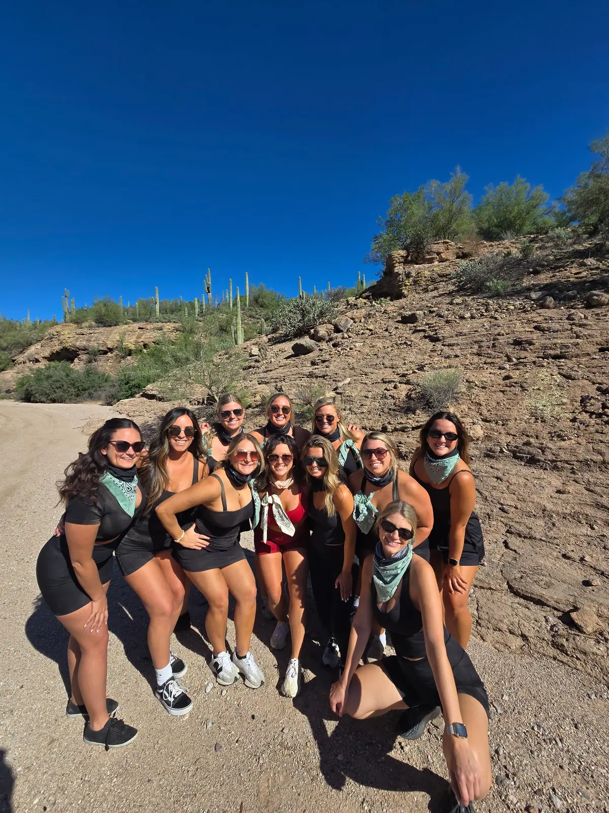A bachelorette group in bandanas on a rocky Scottsdale trail