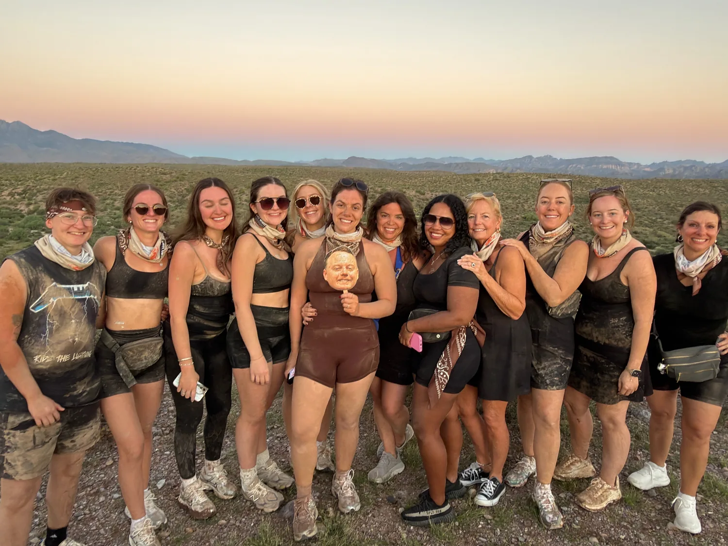 A bachelorette group in matching outfits at desert dusk after their Scottsdale sunset tour