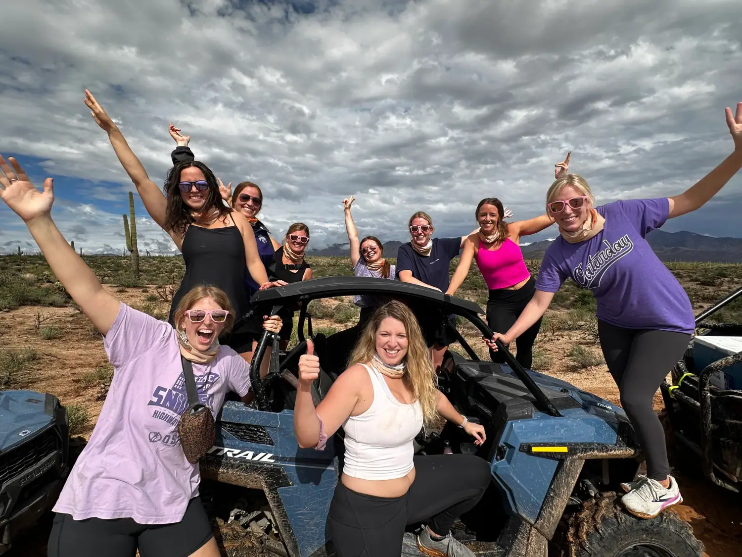 Bachelorette party cheering around their sand buggy in the Scottsdale desert