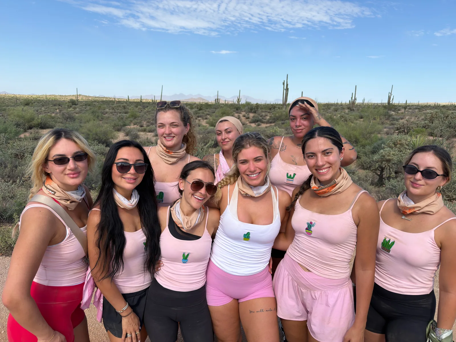 Bachelorette party in matching pink tanks and Desert Dog gaiters among the saguaros near Scottsdale