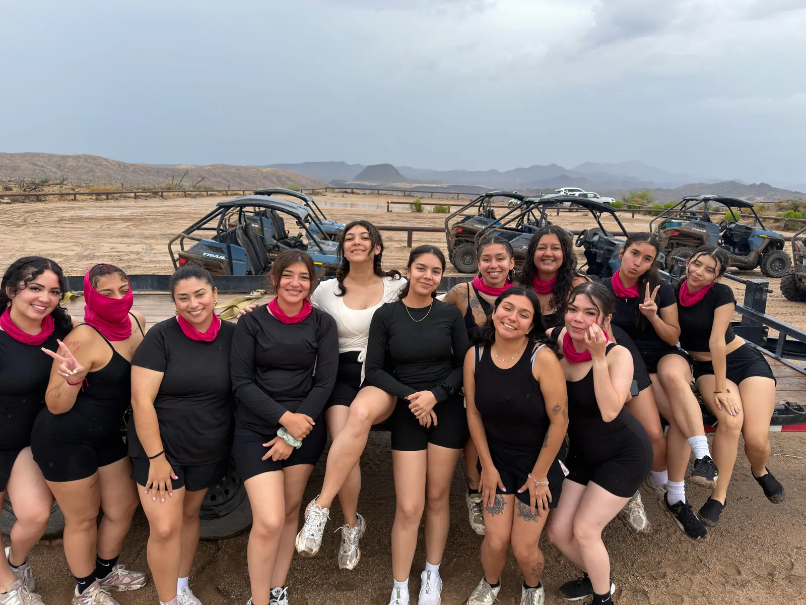 A large bachelorette party in matching outfits in front of a Desert Dog UTV fleet near Scottsdale
