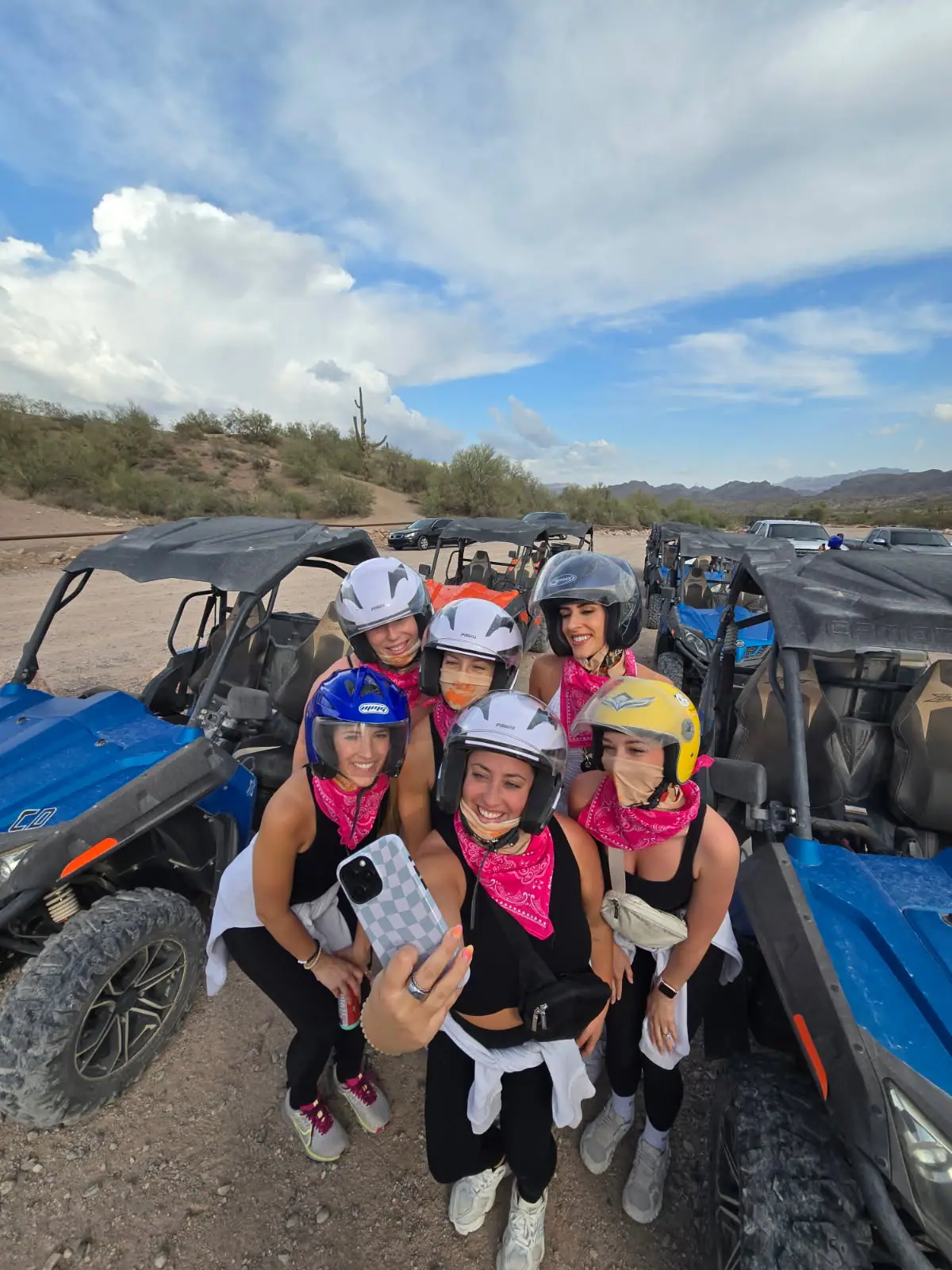 A bachelorette group selfie by the sand buggies