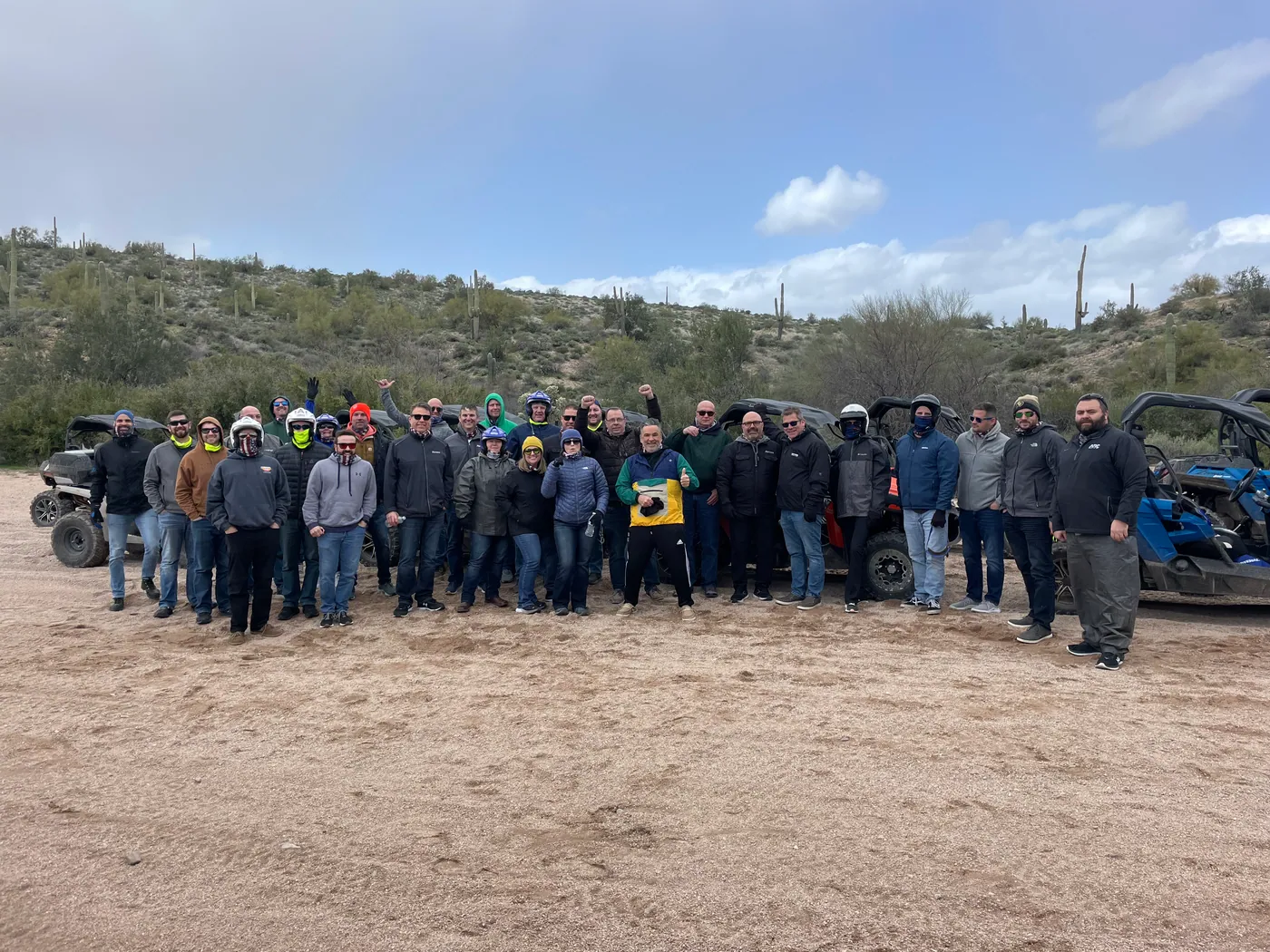 A corporate group bundled up with their buggies on a winter Scottsdale desert tour