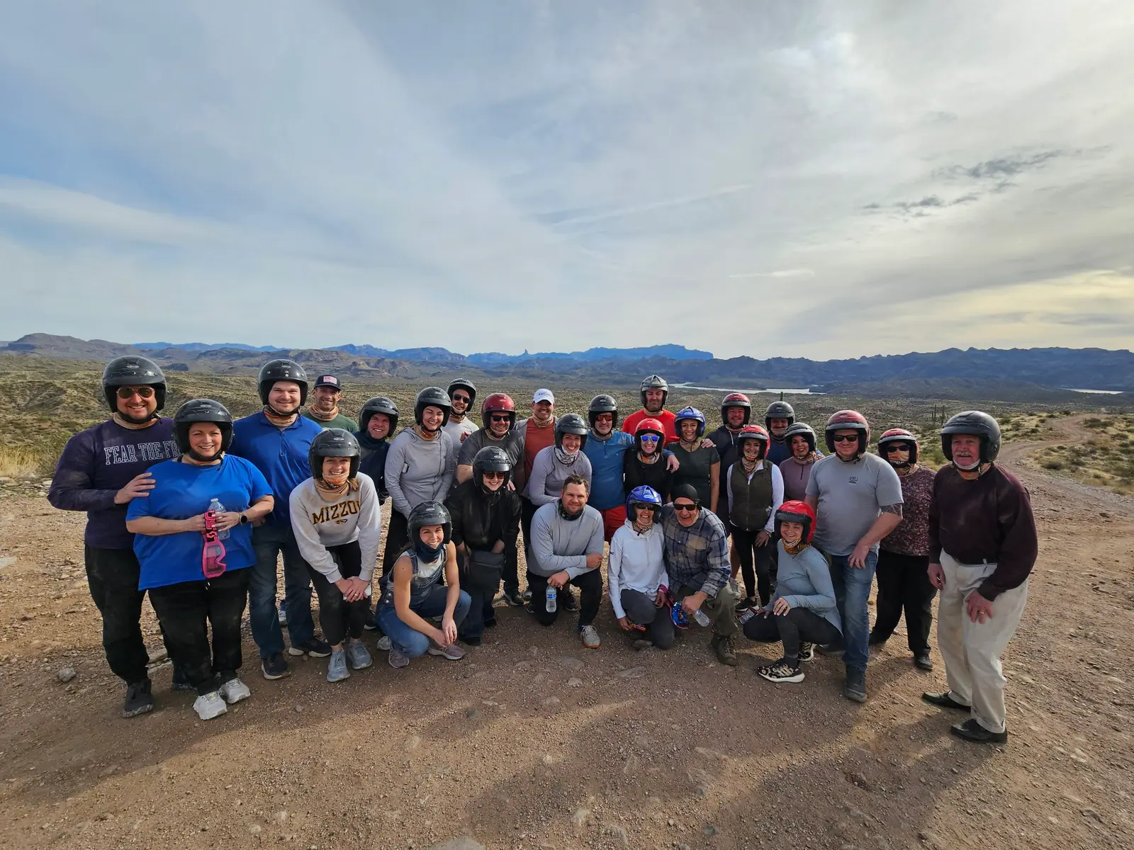 A corporate team in helmets at dusk in the Scottsdale desert