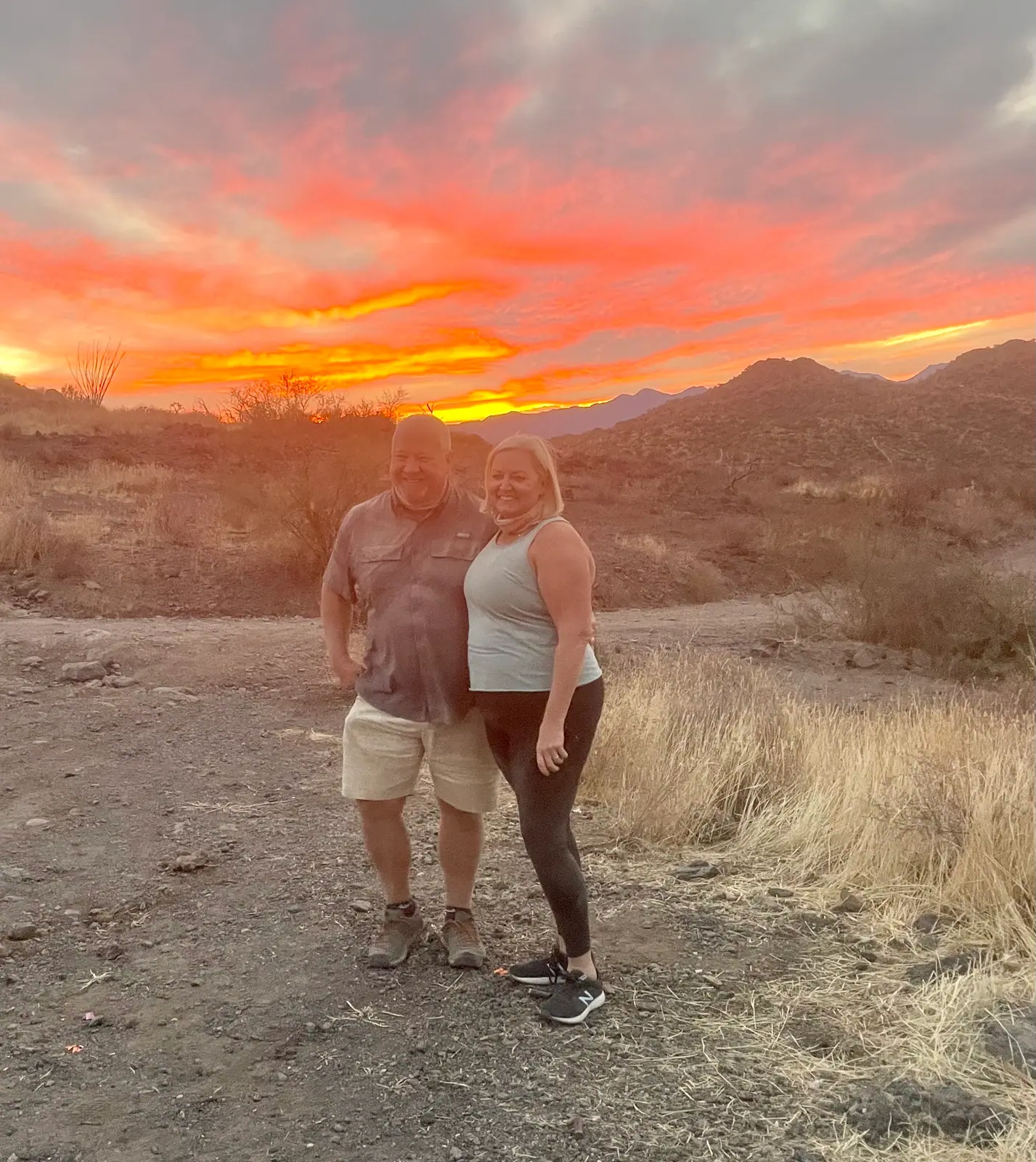 A couple at a fiery sunset on a Scottsdale desert tour