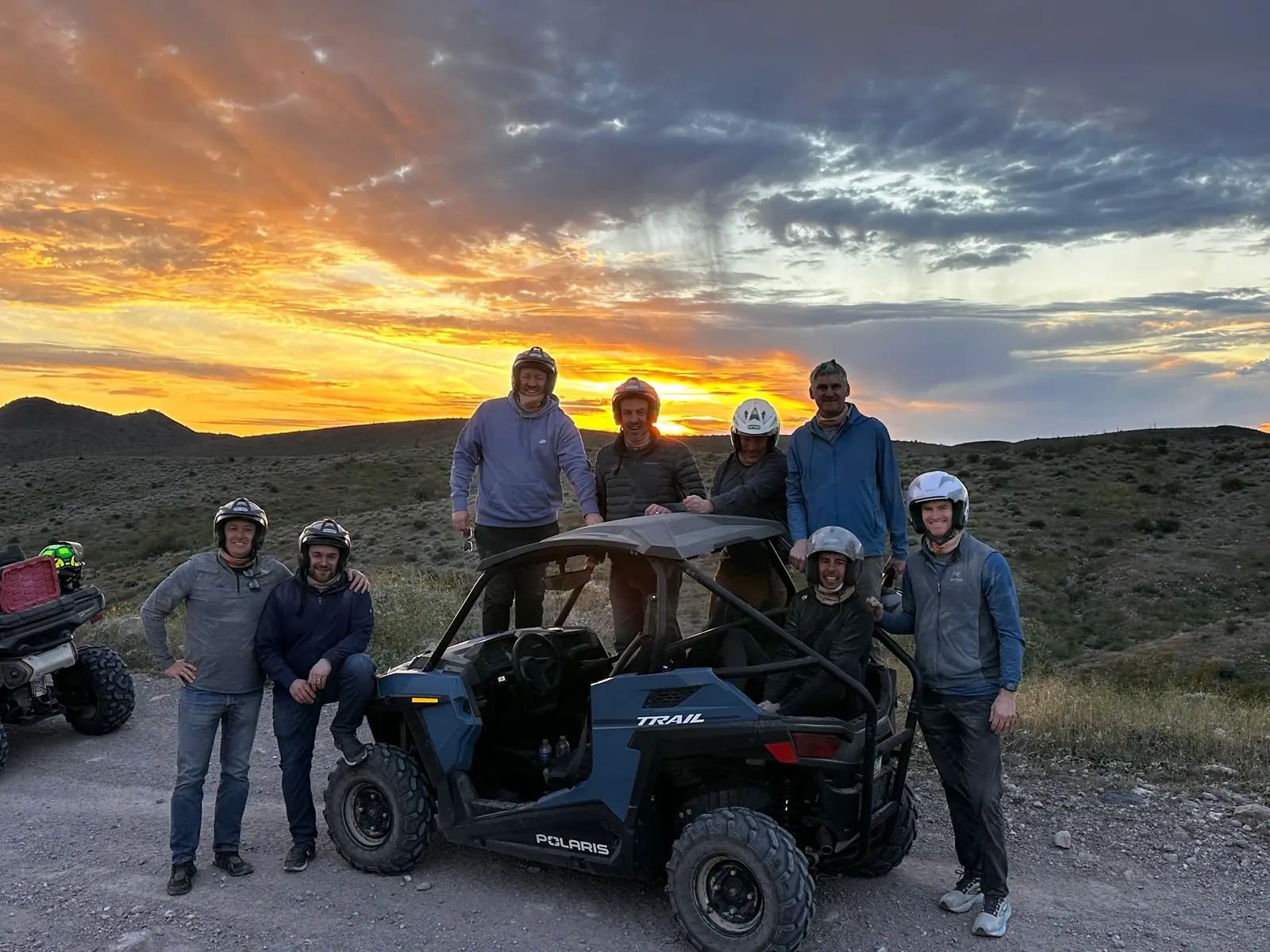 A family together beside their Polaris RZR at sunset in the Scottsdale desert