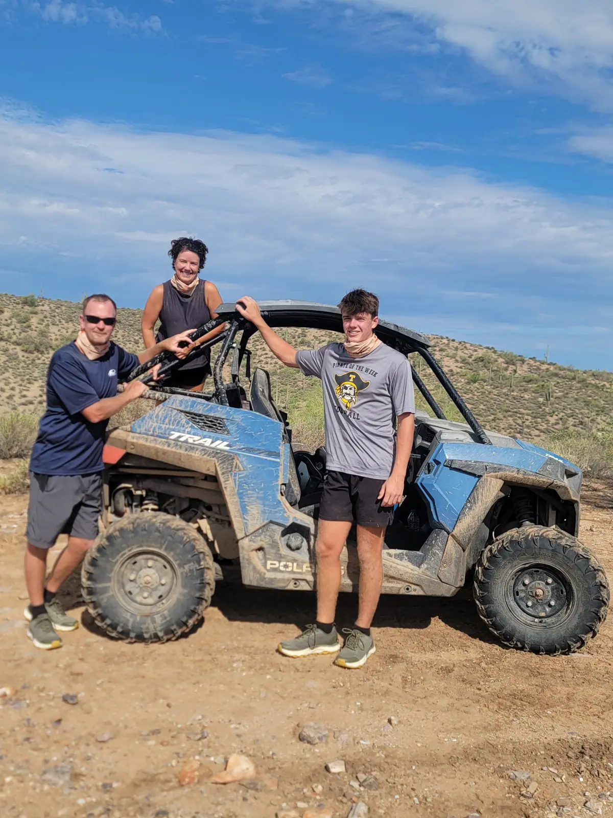 A family posing with a Polaris Trail UTV on a Scottsdale desert off-road tour