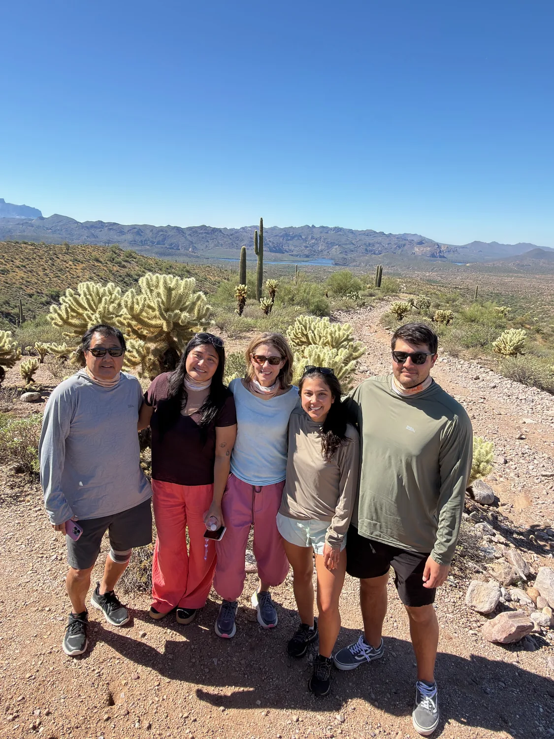 A group on a rocky desert trail lined with cholla and saguaro near Scottsdale, the kind of foothill habitat where Gila monsters live