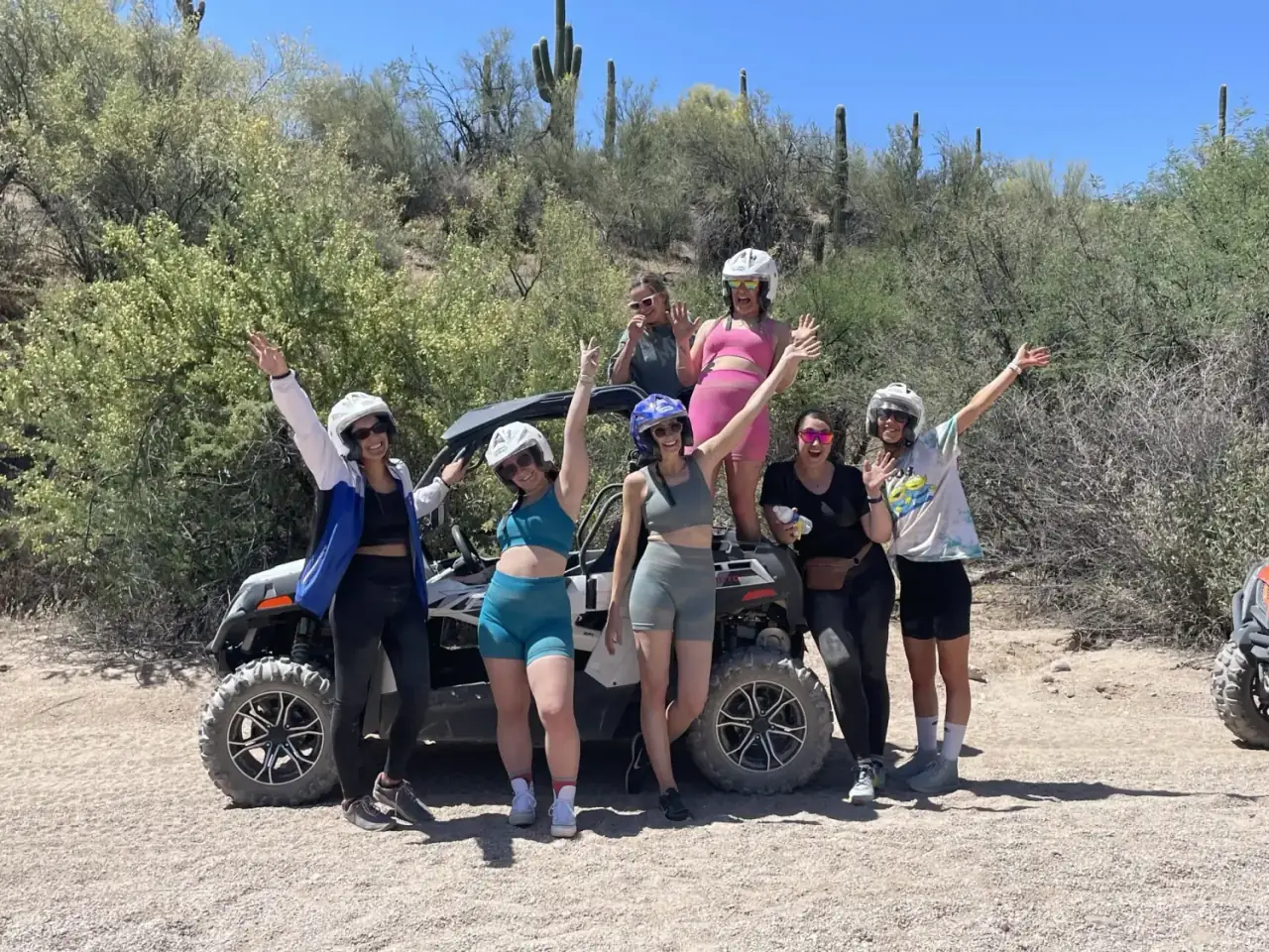 Group of women celebrating after a sand buggy adventure