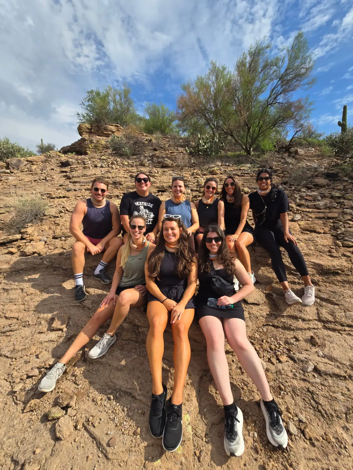 A group on a Scottsdale desert adventure resting on the rocks