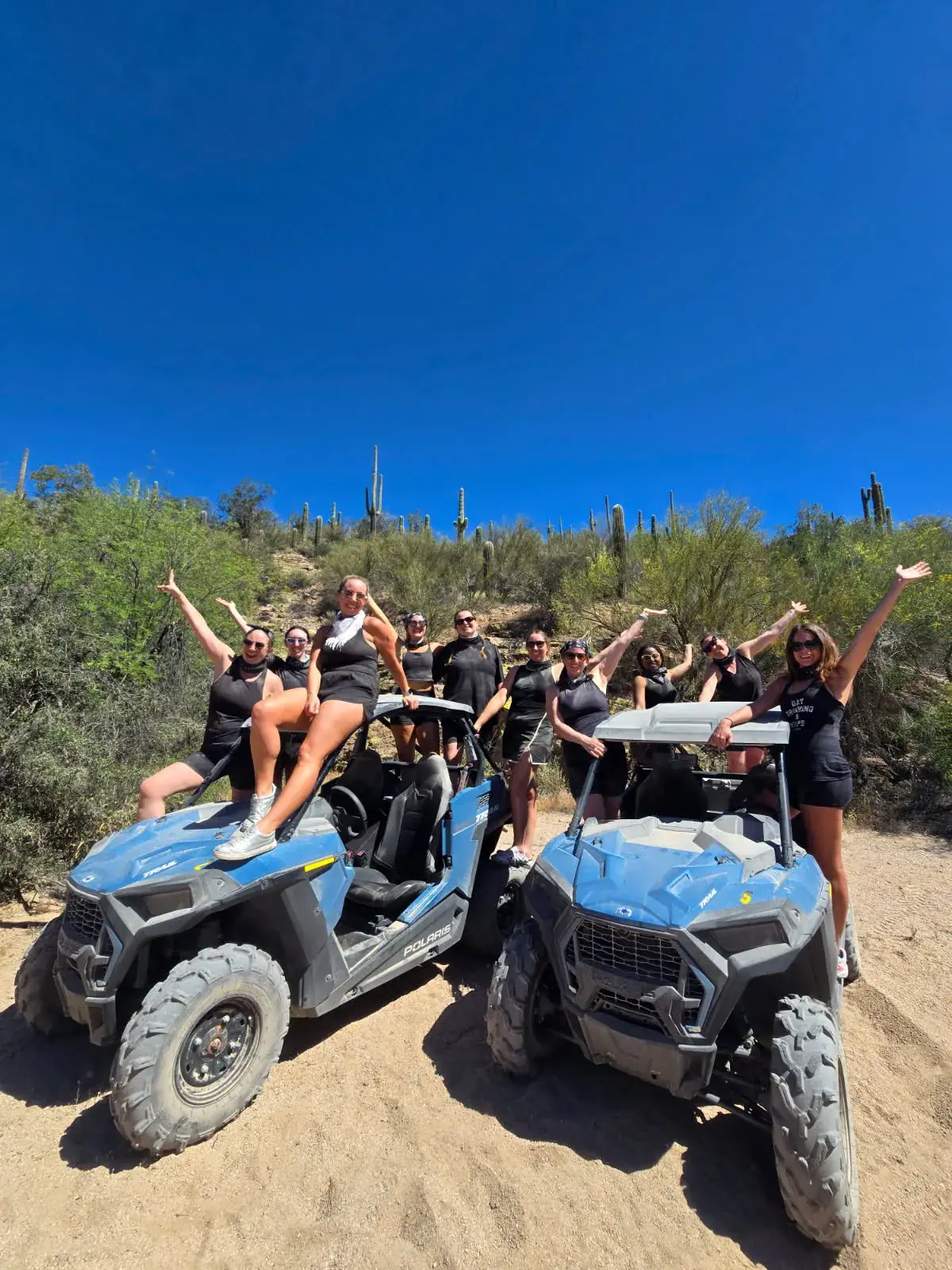 Friends celebrating after an ATV adventure in the desert