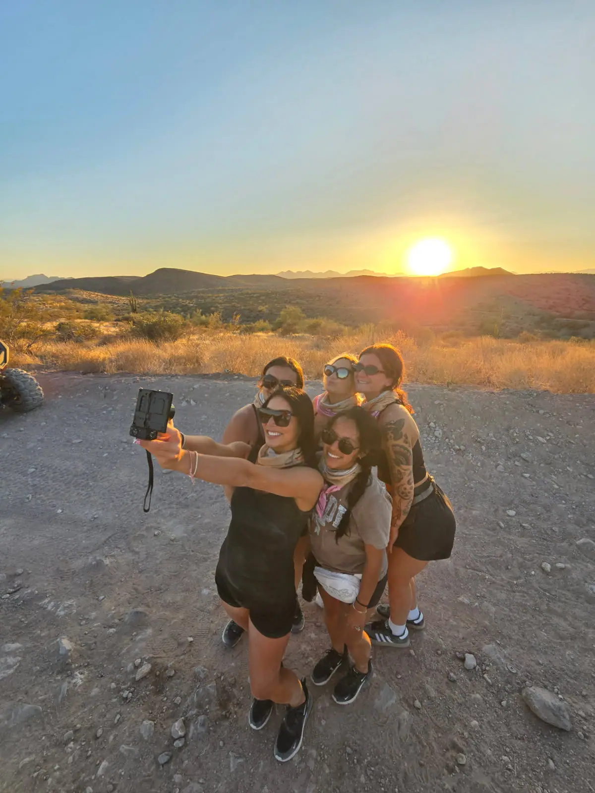 A group selfie at sunset on a Scottsdale desert tour