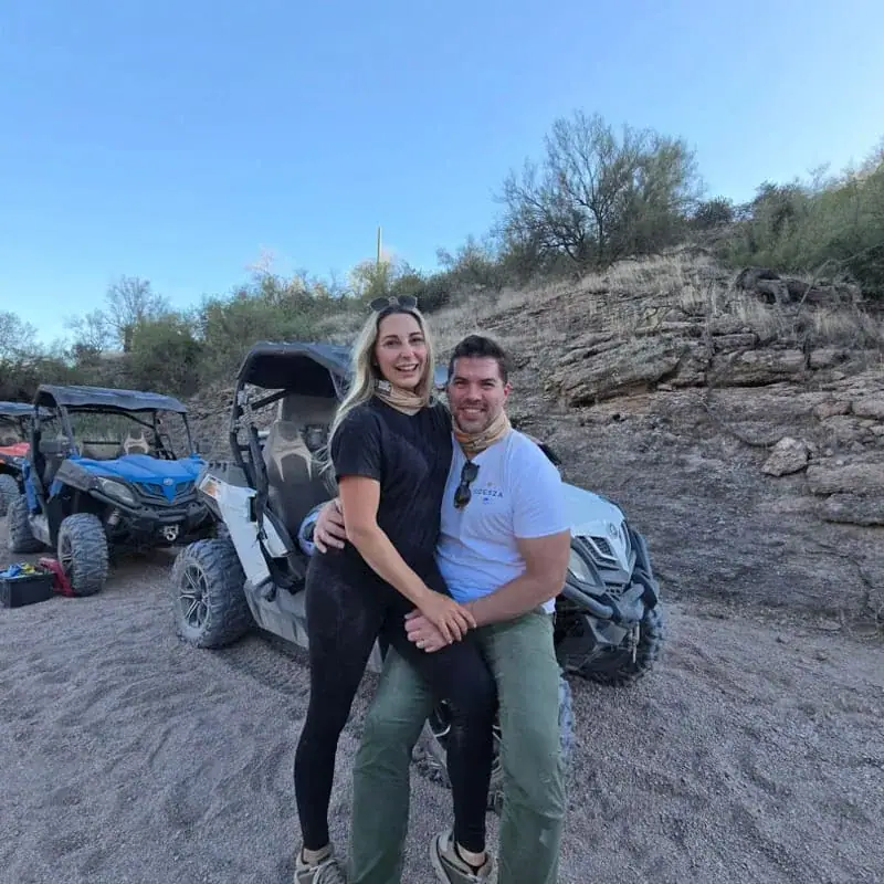 Happy couple enjoying their off-road adventure at sunset