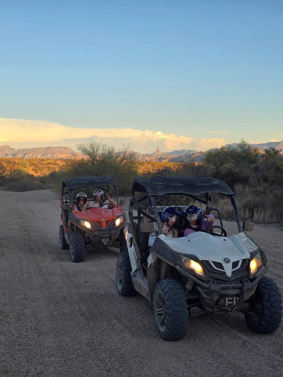Two UTVs on a desert trail during golden hour