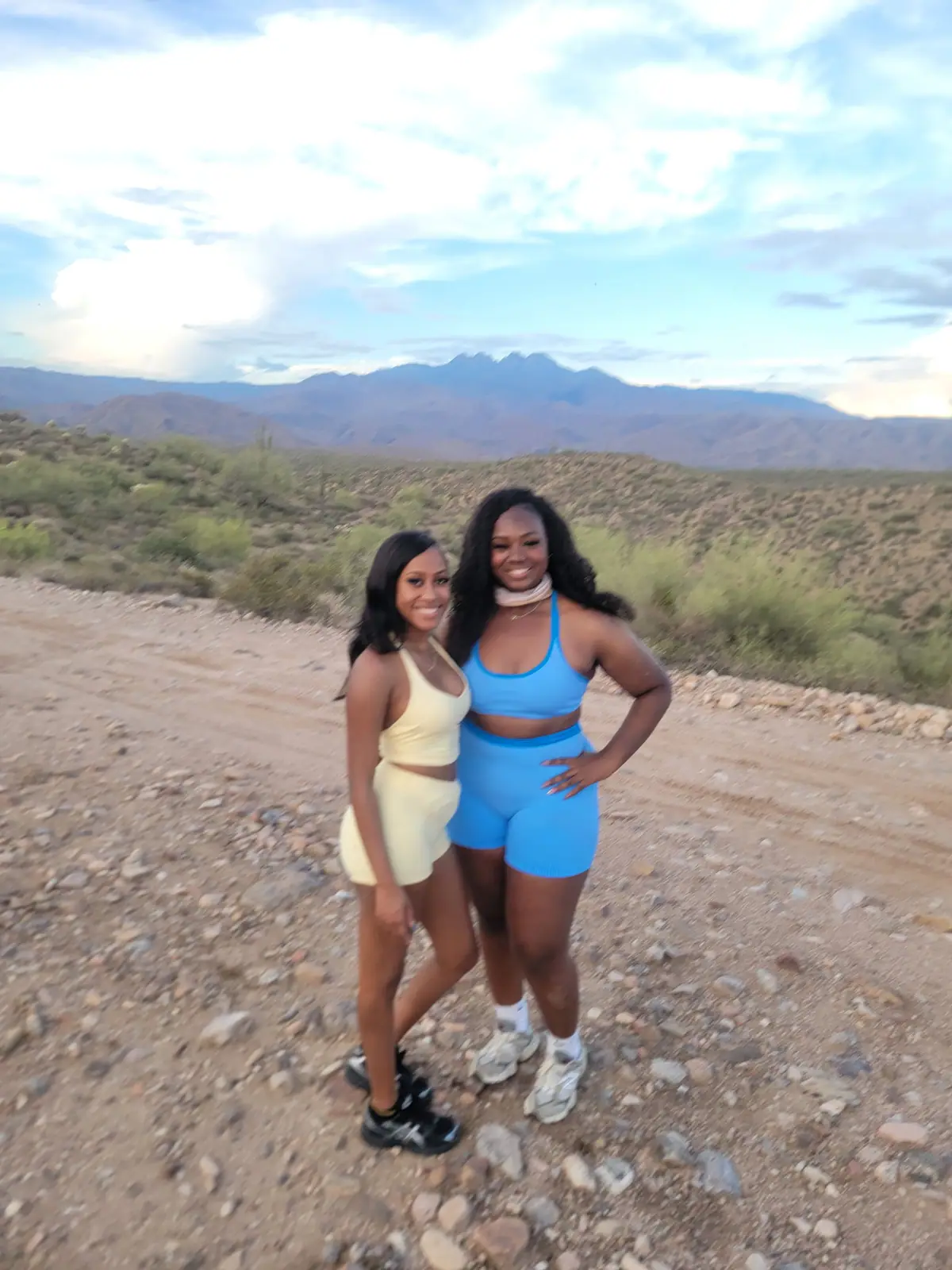 Two women posing with the Four Peaks mountains behind them on a Scottsdale desert tour